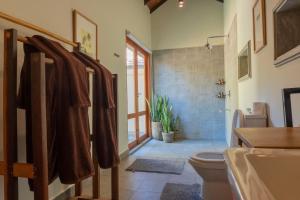 a bathroom with a toilet and a shower and a sink at The Spice Trail in Arugam Bay