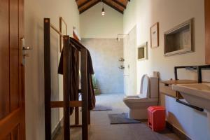 a bathroom with a toilet and a sink at The Spice Trail in Arugam Bay