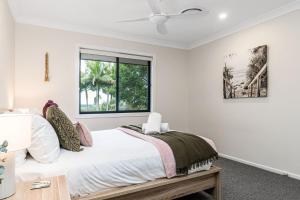 a bedroom with a large bed and a window at Serenity Now in Lennox Head