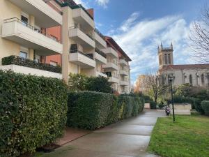 a sidewalk next to a building and a church at Laissepassetemps in Marseille