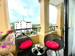 a balcony with two chairs and a table at Nereus Hotel in Con Dao