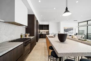 a kitchen with a counter with a stove top oven at Luxury KH Chalet in Mount Hotham