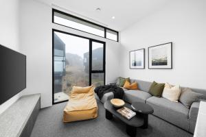 a living room with a couch and a table at Luxury KH Chalet in Mount Hotham