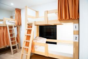 two bunk beds in a room with a numbered floor at Upper Hotel Ryogoku in Tokyo
