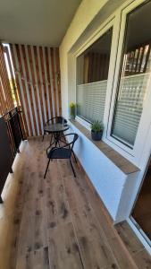 a porch with a table and two windows at Gdynia Wyjątkowy Apartament przy Lesie by Noclegi Renters in Gdynia +22 photos