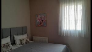Postel nebo postele na pokoji v ubytování Nymfes House.