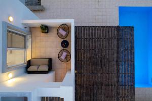 a small room with a couch and a window at Adore Lindos Villa in Líndos