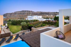 a view from the roof of a house with a pool at Adore Lindos Villa in Líndos