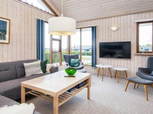 a living room with a couch and a table at 4 star holiday home in Juelsminde-By Traum in Sønderby