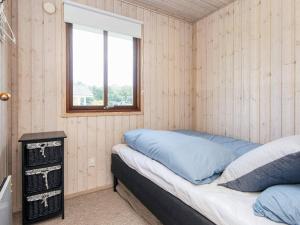 a bedroom with a bed in a room with a window at 4 star holiday home in Juelsminde-By Traum in Sønderby