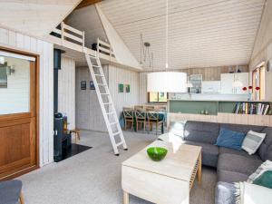 a living room with a couch and a loft bed at 4 star holiday home in Juelsminde-By Traum in Sønderby +28 photos