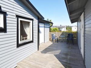 a patio with a table and chairs next to a building at 10 person holiday home in Skummeslövsstrand in Skummeslövsstrand