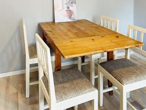 a wooden dining room table with two chairs and a table at 4 person holiday home in Nösund in Nösund +13 photos