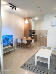 a living room with a table and a kitchen at The ocean city view in Kota Kinabalu