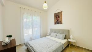 a bedroom with a bed and a picture on the wall at Villa Anastasia ,150 m to Coral Bay beach in Peyia +19 photos