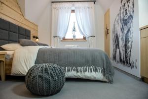 a bedroom with a large bed and a window at DW Boguń Pokoje i Apartamenty in Białka Tatrzańska