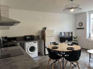 a kitchen and dining room with a table and chairs at Le Grand RepublicainT2 in Le Péage-de-Roussillon