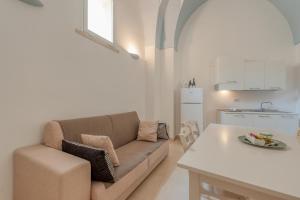 a living room with a couch and a table at Suite Mamma Elvira in Lecce