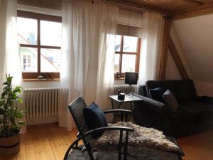 a living room with a couch and a table at Ferienwohnung Beim Bienagassl in Waldsassen