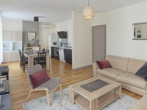 a living room with a couch and a table at Appartement spacieux en centre ville in Vendôme