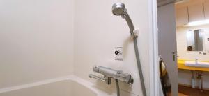 a bathroom with a bath tub and a sink at Yume House in Furano +28 photos