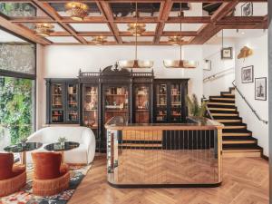a room with a staircase and a table and chairs at Billie Hôtel in Nantes
