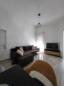 a living room with a couch and a tv at Doana Apartments in Vir