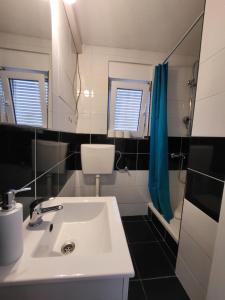 a bathroom with a sink and a toilet and a shower at Doana Apartments in Vir +28 photos