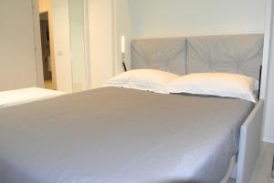 A bed or beds in a room at Duomo Inn