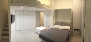 A bed or beds in a room at Duomo Inn