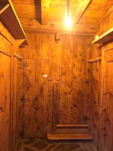 a wooden room with a wooden wall with a door at Maison typique rénovée 4 CHBR lac d'Oô Peyragudes in Oô +29 photos