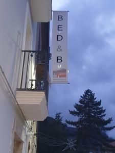 a sign on the side of a building with a tree at B&B Sotto il Figliolo in Petina +37 photos