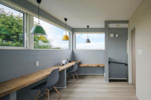 a home office with a desk and two windows at TOWA villa in Otofuke