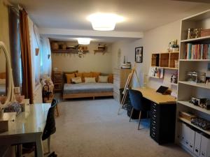 a living room with a desk and a bedroom at Nice HOME in Horní Heršpice