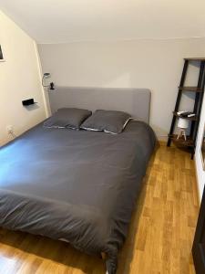 a bed with two pillows in a bedroom at Made in Beaufort in Beaufort-en-Vallée