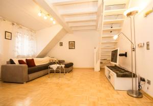 a living room with a couch and a staircase at Ferienwohnung Emilia in Speyer