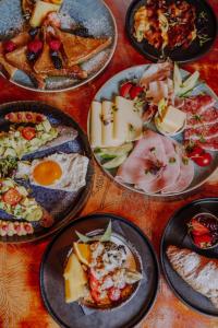 a bunch of plates of food on a table at Hotel Lux in Munich