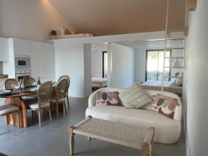 a living room with a couch and a dining room at Casa Barranco in Carrapateira
