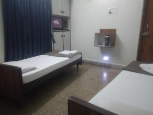 Hotel Kartiki客房内的一张或多张床位