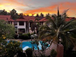 a house with a palm tree and a swimming pool at Amy Village Apartments & Digital Hub in Lamai +151 photos