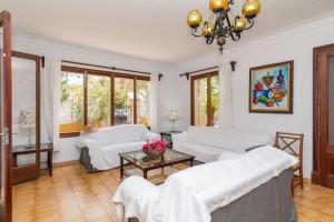 a living room with two beds and a table at Villa Minerva by Sealand Villas in Alcudia +27 photos