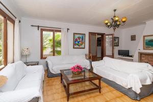 a living room with two white couches and a table at Villa Minerva by Sealand Villas in Alcudia
