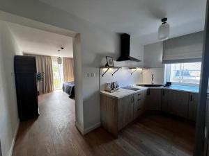 a kitchen with a sink and a counter top at Apartamenty Św Stanisława in Skierniewice