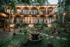a building with a lot of plants in front of it at Grün Resort Uluwatu in Uluwatu