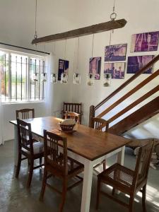 a dining room with a wooden table and chairs at Villa Mia in Trou dʼ Eau Douce