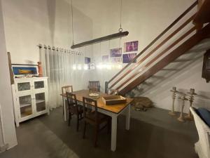 a dining room with a table and chairs and a staircase at Villa Mia in Trou dʼ Eau Douce +12 photos