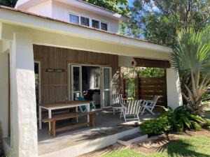 a house with a table and chairs on a patio at Villa Mia in Trou d'Eau Douce