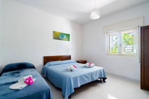 Postel nebo postele na pokoji v ubytování Villa Iris Punta Prosciutto