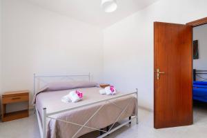 Postel nebo postele na pokoji v ubytování Villa Iris Punta Prosciutto