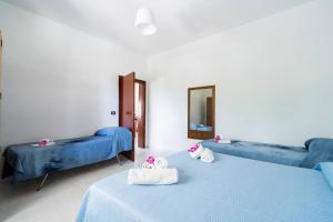 Postel nebo postele na pokoji v ubytování Villa Iris Punta Prosciutto